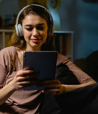 virtual night school student using tablet and headphones